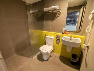 a bathroom with a toilet and a sink at Travelodge Georgetown, Penang in George Town