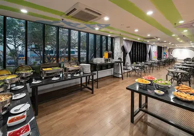 a restaurant with tables filled with food on display at Travelodge Georgetown, Penang in George Town