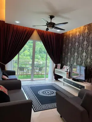 a living room with a couch and a tv at Ipoh The Heyven Lakeside Homestay by Quadvanos in Ipoh