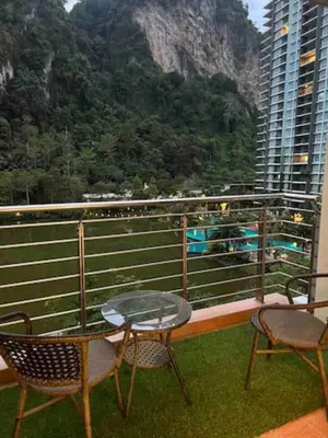 a balcony with a table and chairs and a mountain at Ipoh The Heyven Lakeside Homestay by Quadvanos in Ipoh