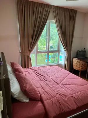a bed in a bedroom with a large window at Ipoh The Heyven Lakeside Homestay by Quadvanos in Ipoh