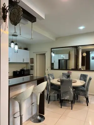 a kitchen and dining room with a table and chairs at Ipoh The Heyven Lakeside Homestay by Quadvanos in Ipoh
