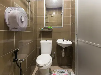 a small bathroom with a toilet and a sink at Chemor Inn in Cemur
