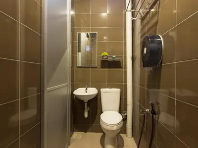 a small bathroom with a toilet and a sink at Chemor Inn in Cemur