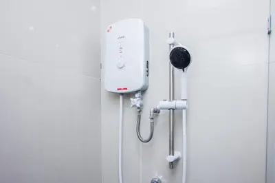 a bathroom with a soap dispenser on the wall at Beachboy Chalet By The Beach in Bukit Lada