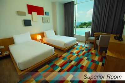 a hotel room with two beds and a table at Casuarina@Meru in Ipoh