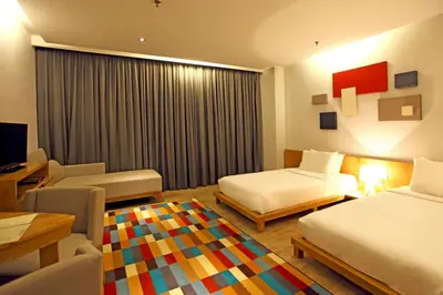 a hotel room with two beds and a television at Casuarina@Meru in Ipoh
