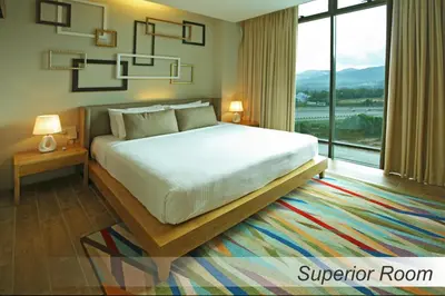 a bedroom with a large bed and a large window at Casuarina@Meru in Ipoh