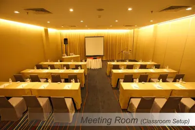 a meeting room with tables and chairs and a whiteboard at Casuarina@Meru in Ipoh