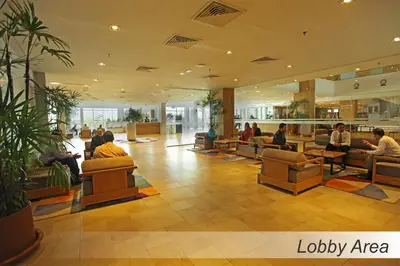 a lobby with people sitting in chairs in a building at Casuarina@Meru in Ipoh