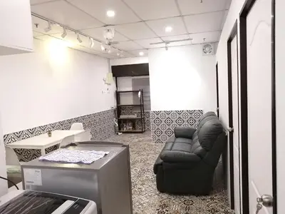 a room with a black chair and a table at Fastbook Ferringhi SoHo unit 8pax in Batu Ferringhi