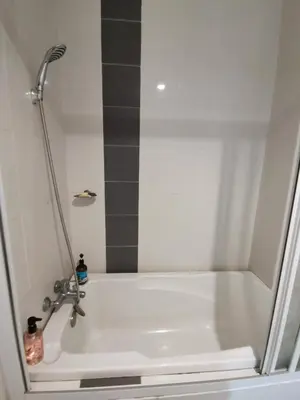a bathroom with a bath tub with a showeruation at Peaceful 1-bedroom unit at Marina Island by JoMy Homestay in Lumut