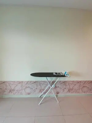 a table with a surfboard sitting on top of it at Peaceful 1-bedroom unit at Marina Island by JoMy Homestay in Lumut