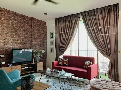 a living room with a red couch and a tv at Lizs Homestay in Ipoh