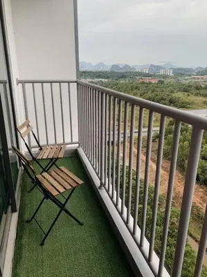 a chair sitting on a balcony with a view at Lizs Homestay in Ipoh
