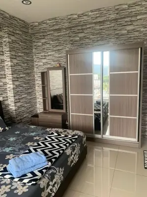 a bedroom with a bed and a large window at Lizs Homestay in Ipoh