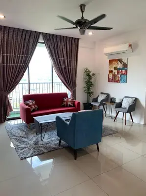 a living room with a red couch and a ceiling fan at Lizs Homestay in Ipoh