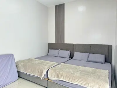 a bed with two pillows on it in a room at Sekinchan 2008 Home：Karaoke/BBQ in Sekincan