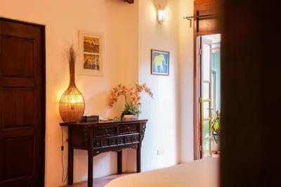 a room with a table with a vase on it at East Indies Mansion in George Town