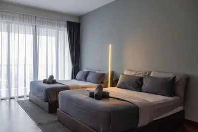 a bedroom with two beds and a large window at Large Family Seaview Suite 3 Rooms by The Only Bnb in Tanjong Tokong