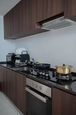 a kitchen with a stove with pots and pans on it at Large Family Seaview Suite 3 Rooms by The Only Bnb in Tanjong Tokong