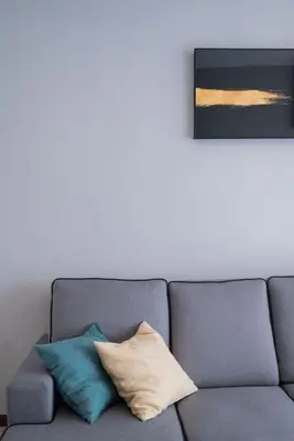a couch with three pillows on it in a living room at Large Family Seaview Suite 3 Rooms by The Only Bnb in Tanjong Tokong