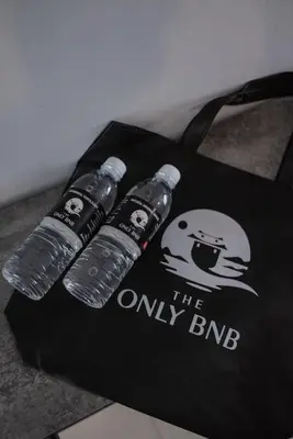 a group of three water bottles on a black bag at Large Family Seaview Suite 3 Rooms by The Only Bnb in Tanjong Tokong