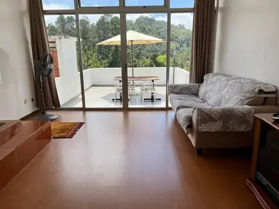 a living room with a couch and a table at THE MILKY WAY @ PINE RESORT in Bukit Fraser