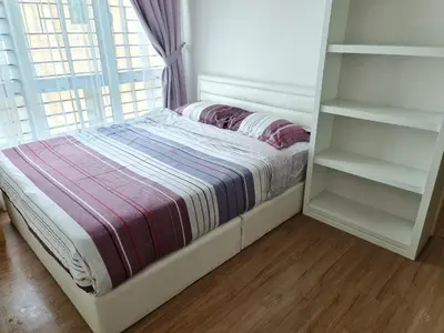 a bed in a room with a window at Pearl Residences Sleep 27 in Batu Ferringhi