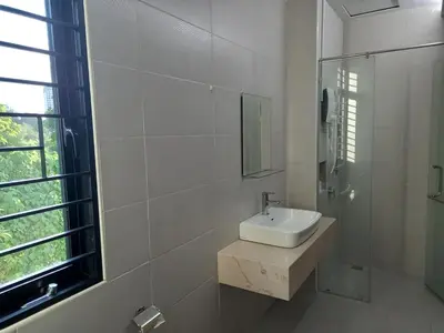 a white bathroom with a sink and a mirror at Pearl Residences Sleep 27 in Batu Ferringhi
