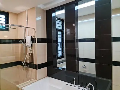 a bathroom with a sink and a mirror at Pearl Residences Sleep 27 in Batu Ferringhi