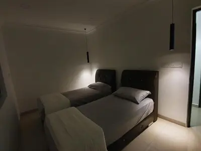 two beds in a room with lights on the wall at Number A Homestay in Raub