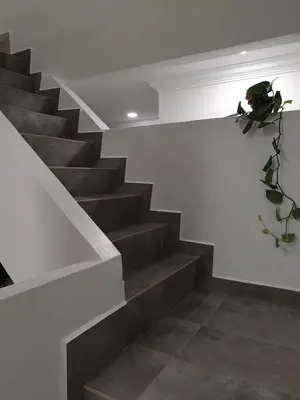 a staircase in a building with a plant on the wall at Number A Homestay in Raub