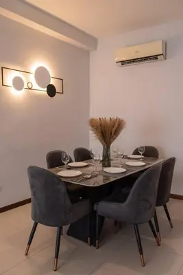a dining room with a table and chairs at Family Seaview Suite with 3 Rooms by The Only Bnb in Tanjong Tokong