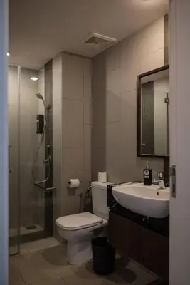 a bathroom with a shower and a toilet and a sink at Deluxe Seaview Suite Twin Bed by The Only Bnb in Tanjong Tokong