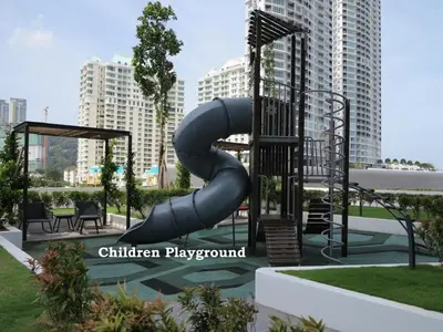 a playground with a slide in a park with tall buildings at Deluxe Seaview Suite Twin Bed by The Only Bnb in Tanjong Tokong