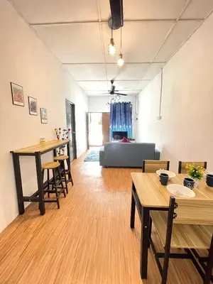 a living room with wooden tables and a couch at Cozy 18 Entire 3 Bedroom @Alma Bukit Mertajam in Bukit Mertajam