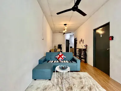 a blue couch in a living room with a ceiling fan at Cozy 18 Entire 3 Bedroom @Alma Bukit Mertajam in Bukit Mertajam