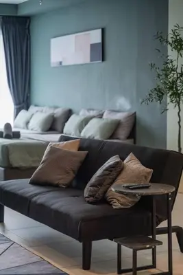 a couch with pillows and a table in a living room at Deluxe Seaview Suite Twin Bed by The Only Bnb in Tanjong Tokong