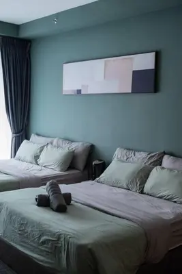 a bedroom with two beds with a stuffed animal on the bed at Deluxe Seaview Suite Twin Bed by The Only Bnb in Tanjong Tokong