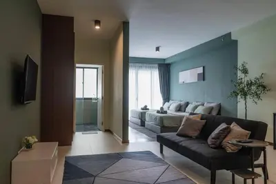 a living room with a couch and a bed at Deluxe Seaview Suite Twin Bed by The Only Bnb in Tanjong Tokong