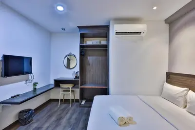 a hotel room with a bed and a desk and a computer at Q Collection Macalister formerly known as Apple Hotel Penang in George Town