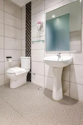a bathroom with a toilet and a sink at Q Collection Macalister formerly known as Apple Hotel Penang in George Town