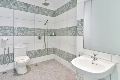 a bathroom with a toilet and a sink at Q Collection Macalister formerly known as Apple Hotel Penang in George Town