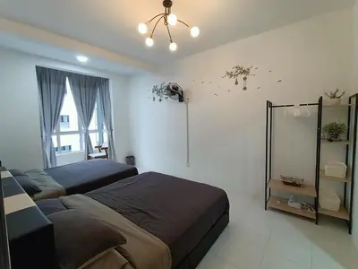 a bedroom with two beds and a chandelier at Dream 3 @ Emerald avenue in Brinchang