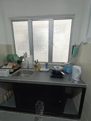 a kitchen counter with a sink and two windows at Dream 3 @ Emerald avenue in Brinchang