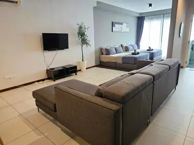 a living room with a couch and a bed at Deluxe Seaview Suite Twin Bed by The Only Bnb in Tanjong Tokong