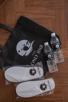 a bag and two bottles of water on a table at Deluxe Seaview Suite Twin Bed by The Only Bnb in Tanjong Tokong