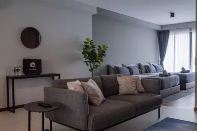 a living room with a couch and a table at Deluxe Seaview Suite Twin Bed by The Only Bnb in Tanjong Tokong
