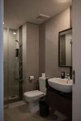 a bathroom with a toilet and a sink and a shower at Deluxe Seaview Suite Twin Bed by The Only Bnb in Tanjong Tokong